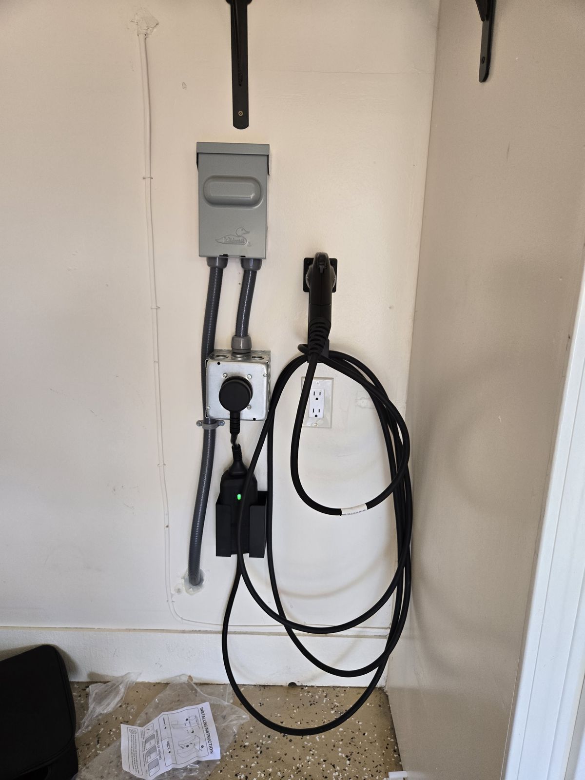 Wall-mounted home EV charger with disconnect