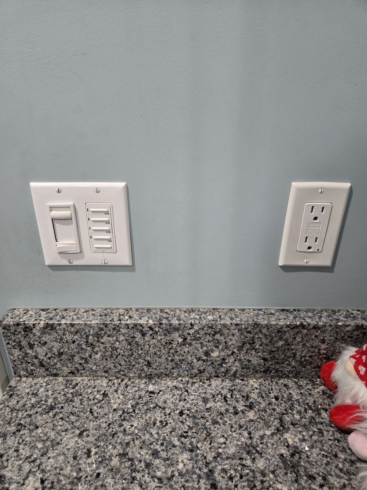 Fan speed control and outlet above a granite countertop