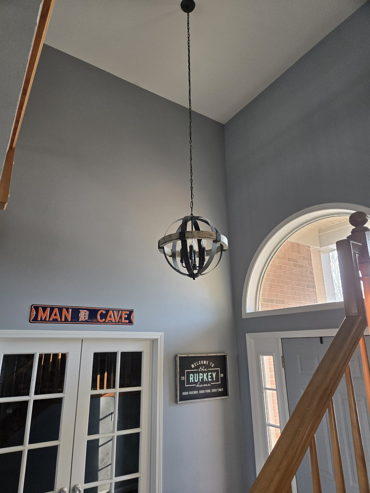 Orb pendant light in a two-story foyer