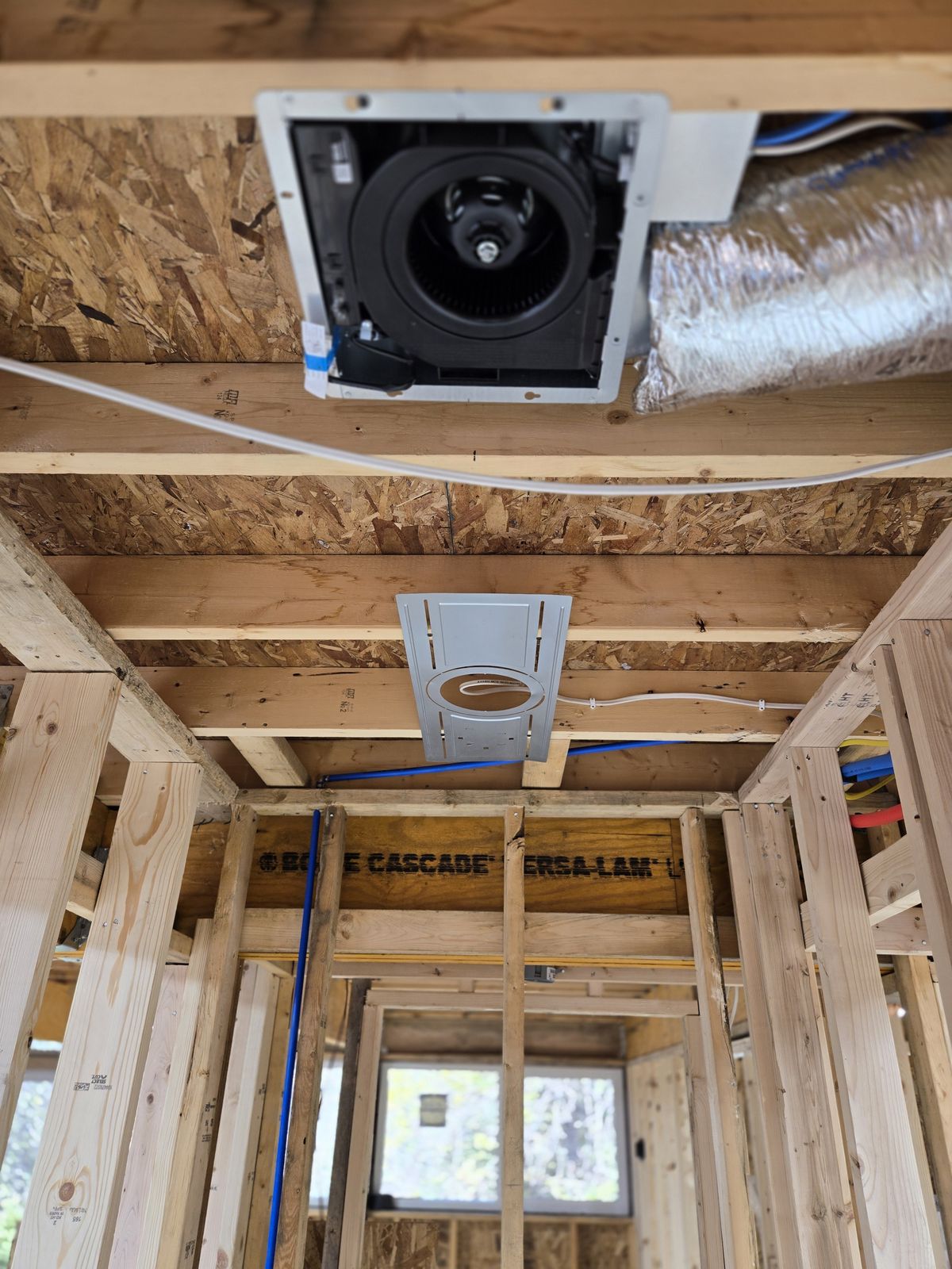 Rough-in wiring and exhaust fan in a new bathroom