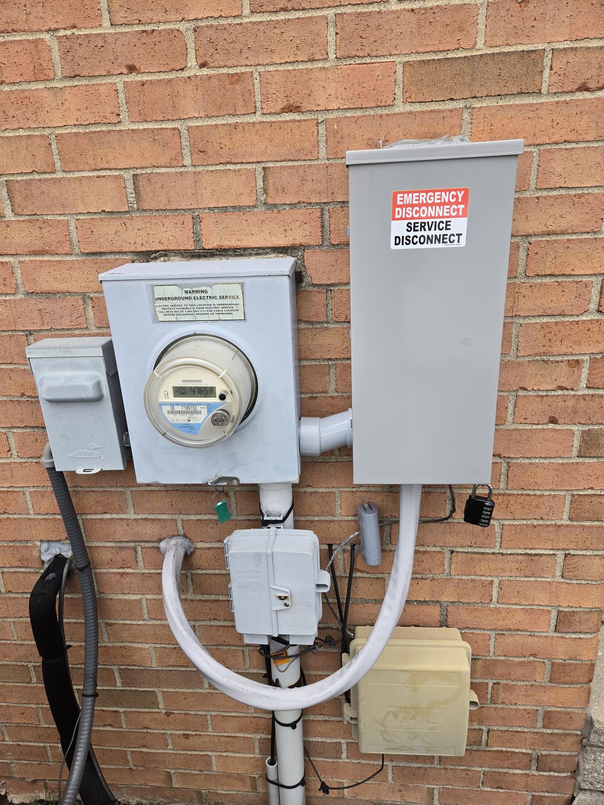 Whole-home surge protector and service disconnect at the electric meter